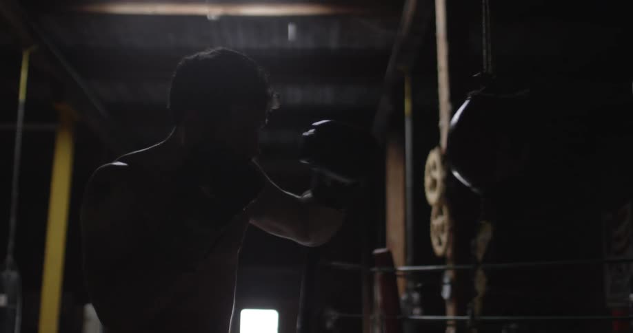 A boxer hits a punching bag