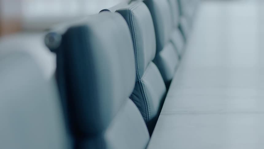 A conference table sits empty in a boardroom during the day