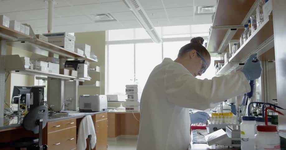A woman in a lab working with a specimen