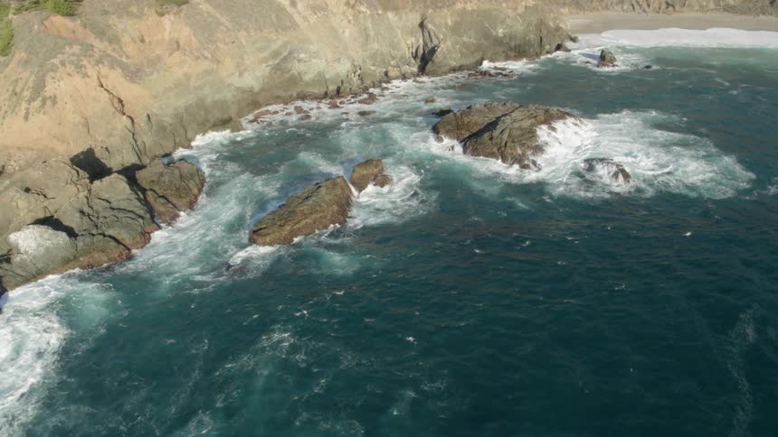 Waves flow towards the rocky shore