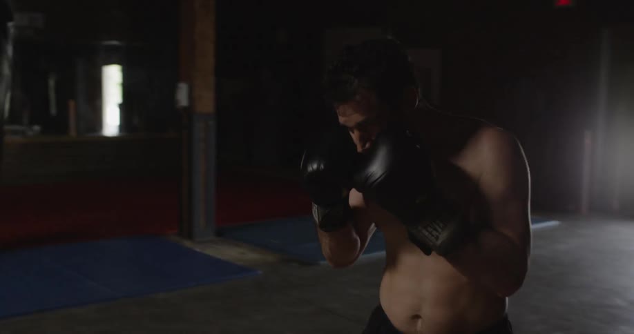 A man spins around a heavy bag punching it