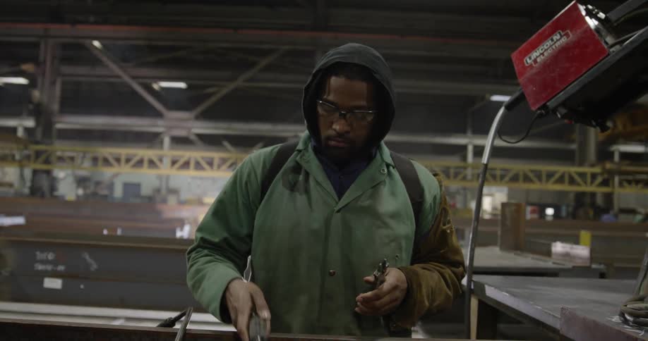 A man adjusts a welding torch