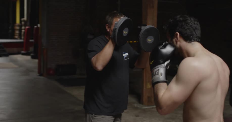 Someone is practicing sparring with their coach