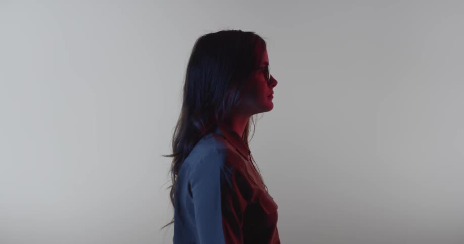 A girl is standing and staring into the distance
