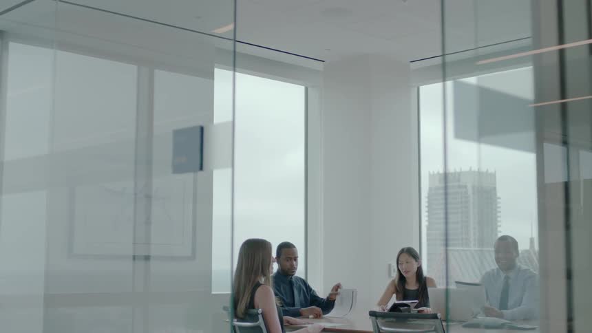Workers are gathered in a conference room