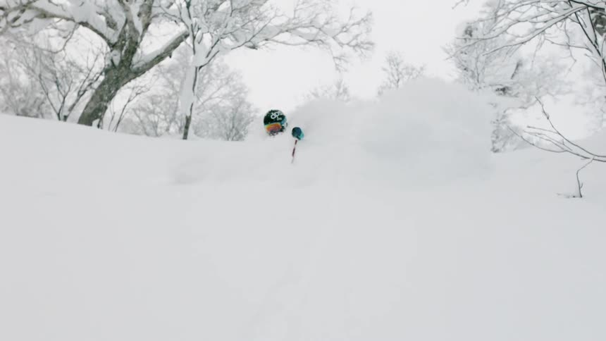 A skier turns through deep snow