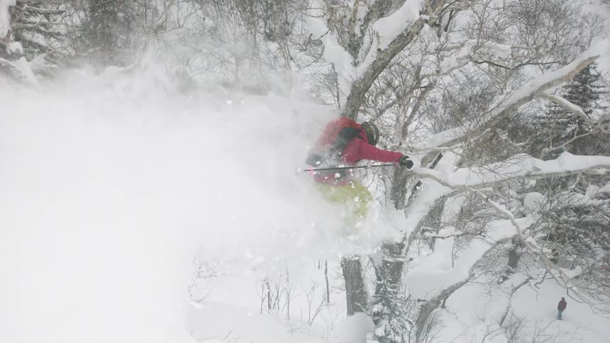 A skier airs through the snow