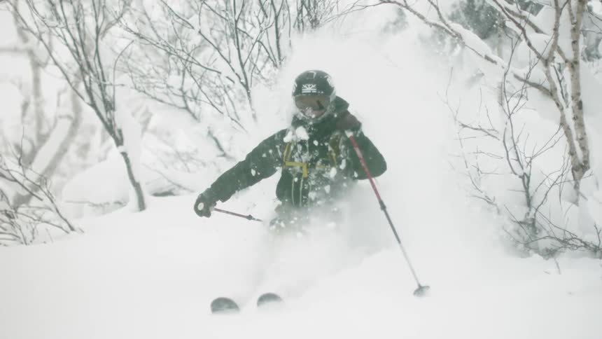 A skier turns through the snow