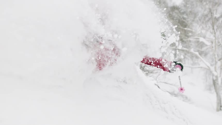 A skier turns through the snow