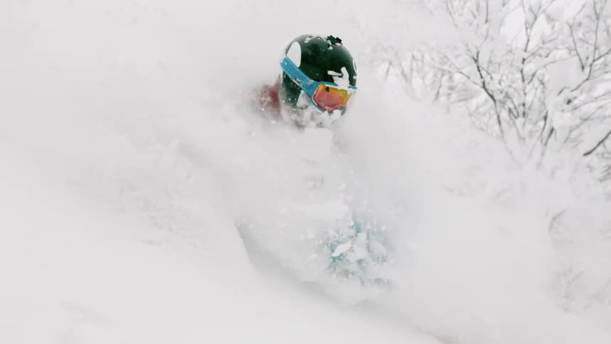 Skier moving through a cloud of snow