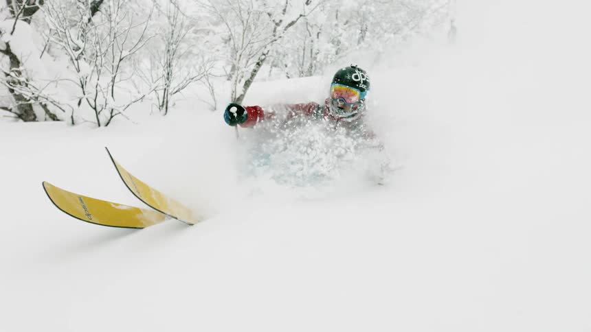 A skier turns through deep powder snow