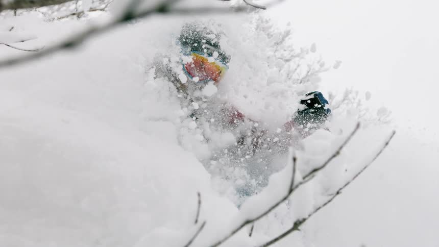 A skier turns through deep snow