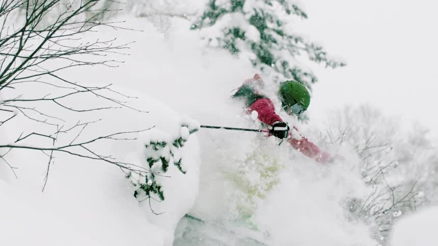 A skier turns through the snow