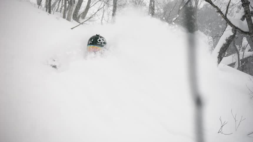 A skier turns through the snow