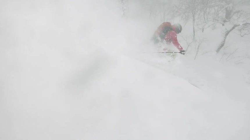 A skier turns through the snow