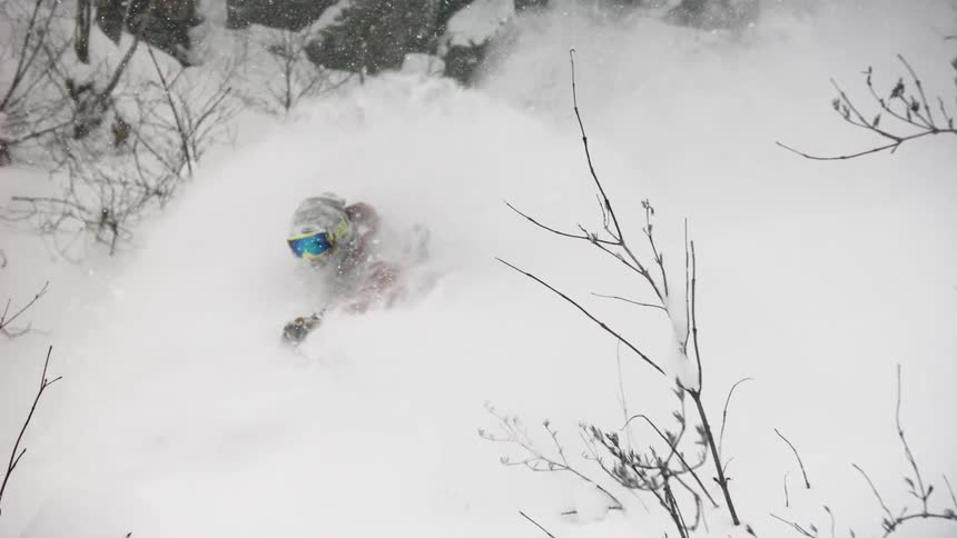 A skier turns through the snow