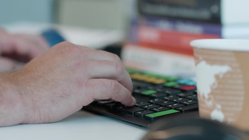 A man types on a keyboard