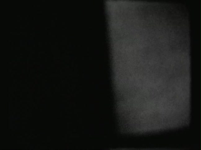 A tv screen is in the dark and full of static