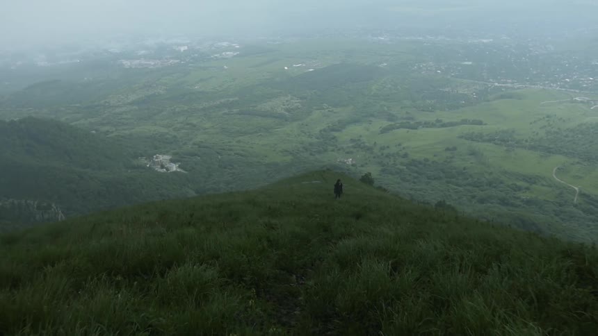 A haze is hanging in the air over a mountain valley during the day