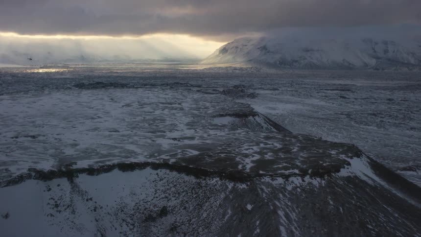 A plateau and mountain valley partially covered in snow