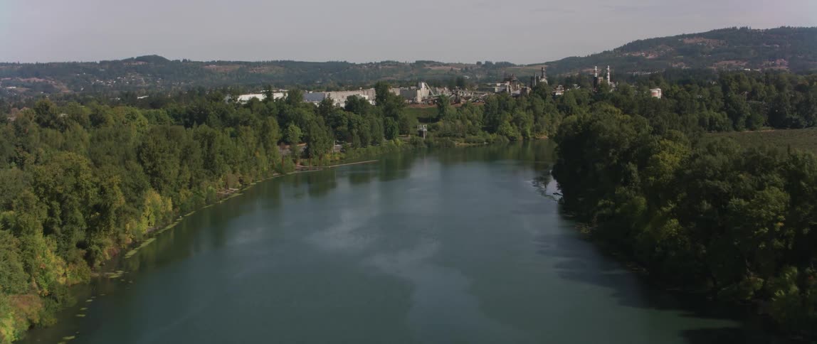 A river flows by factory buildings