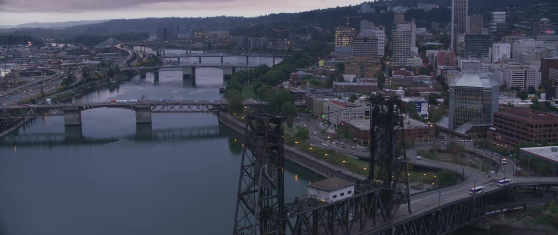 Water flows under several bridges surrounded by a city