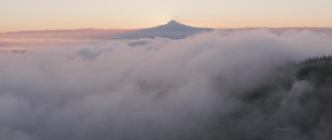 Fog and haze lift above a mountain valley