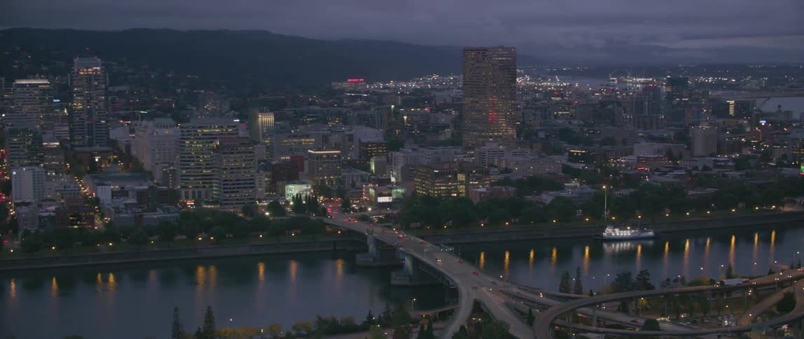 Tall city buildings illuminate the night sky