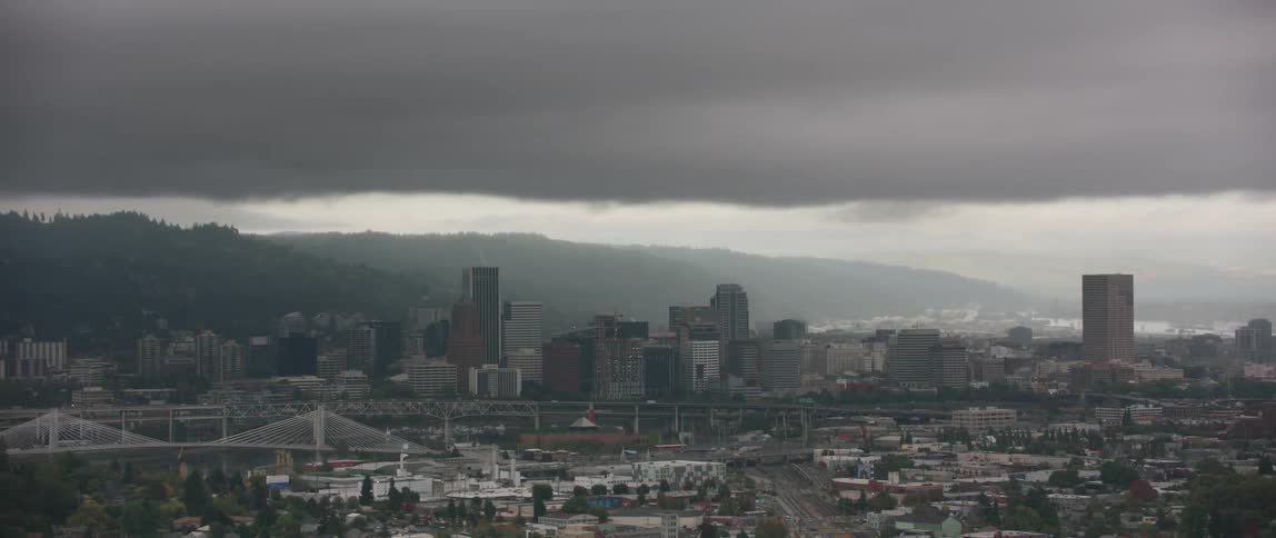 Clouds float above city skyscrapers