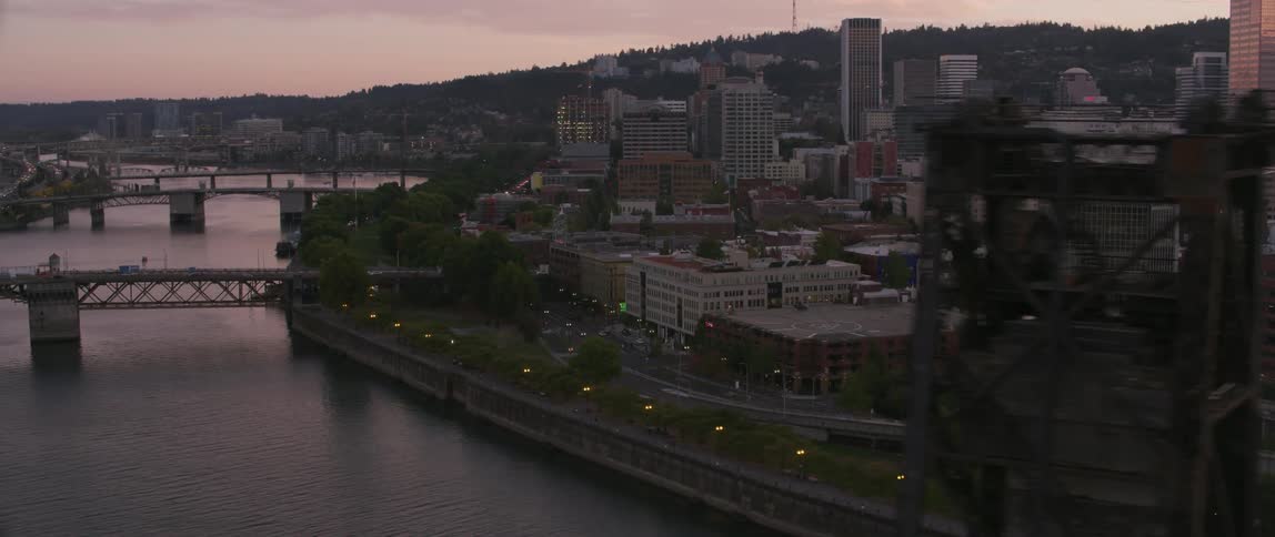 Sun sets over a large city and river