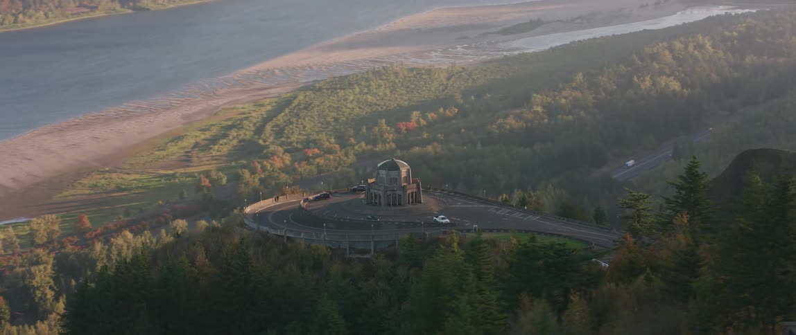 A building sits on a roundabout on a mountain road