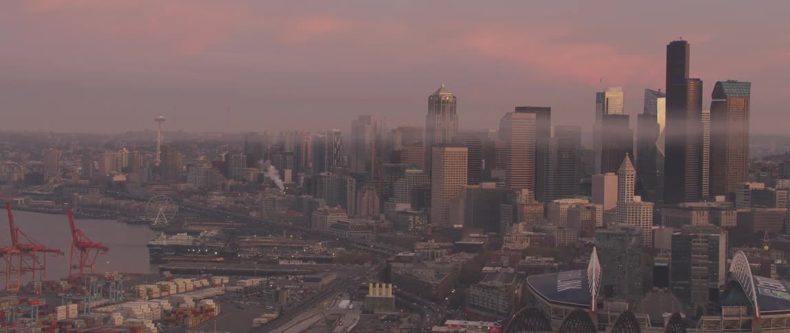 Haze floating over a large city at sunset