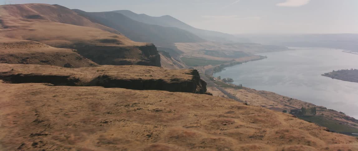 Haze is lingering over a remote coastline during the day