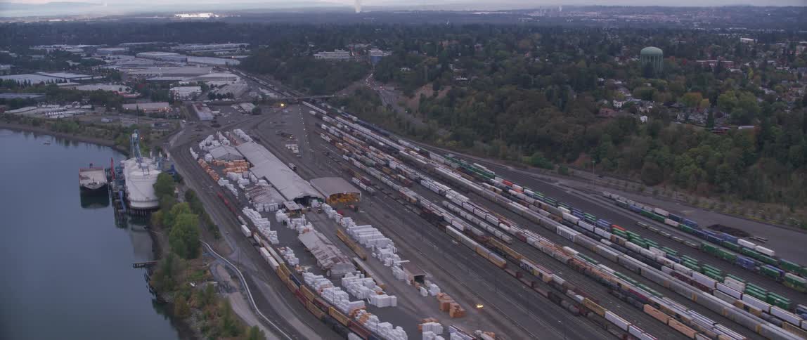 Looking down at a rail yard with many train cars lined up