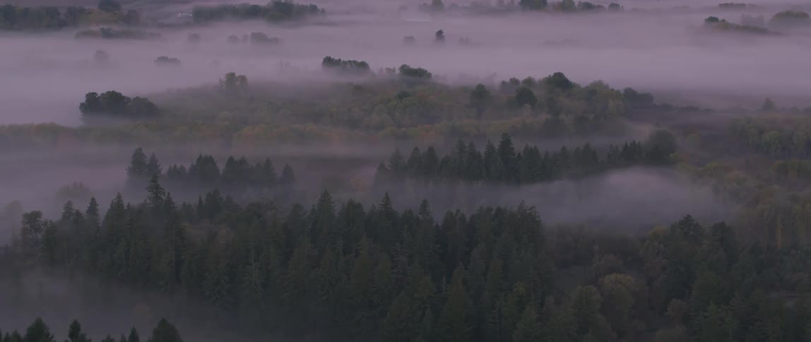 Fog and haze lift above the valley