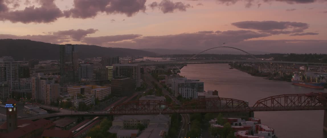 Sun sets over a large city and river