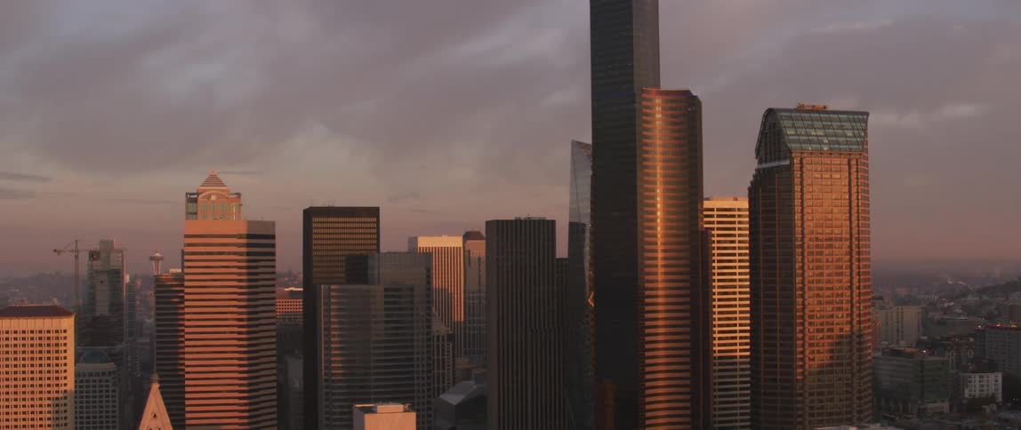 Buildings stand tall under a cloudy blue sky