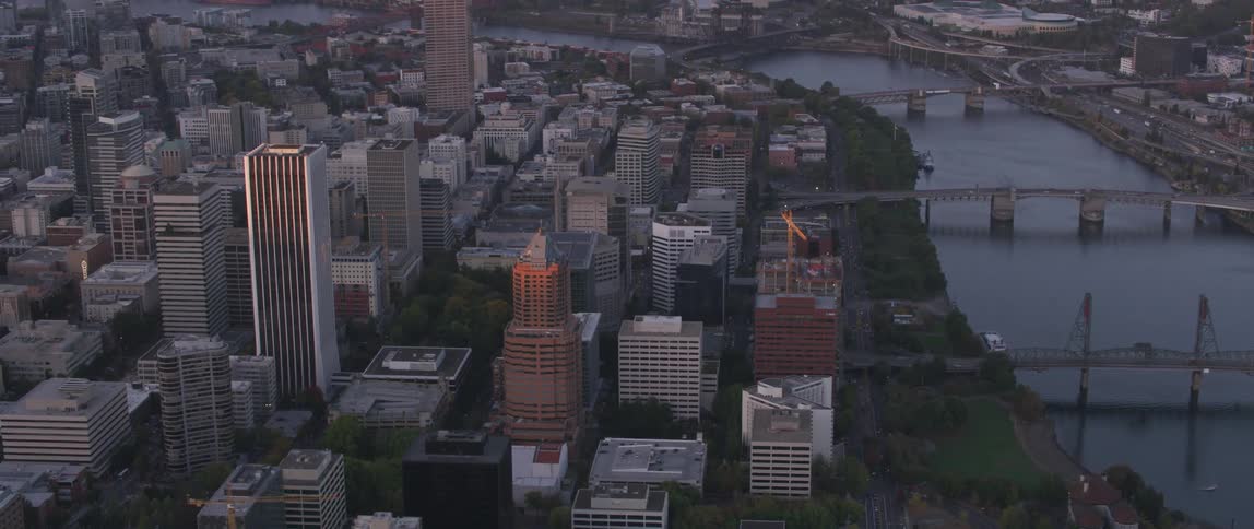 Sunset reflecting off buildings in a city near a river