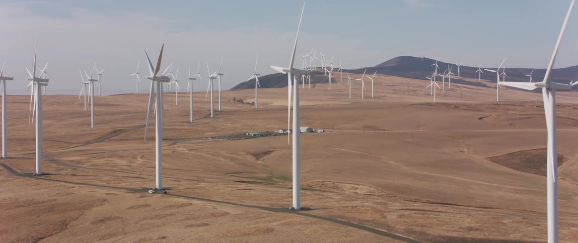 Windmills spin in a large open field