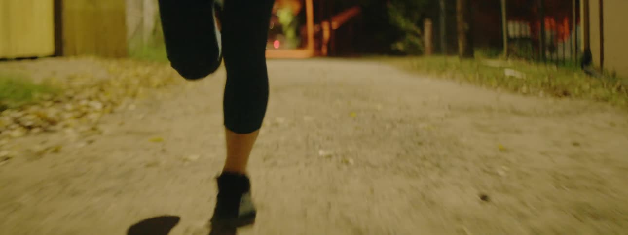 A woman jogs down the street