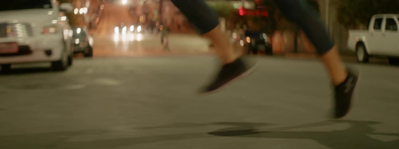 A woman jogs on a city street