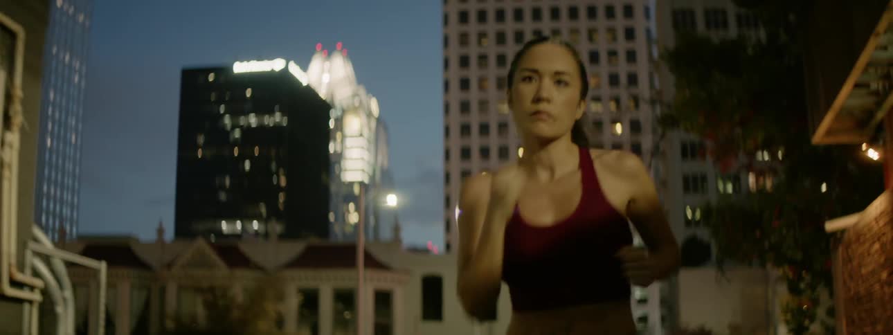 A woman jogs down the street