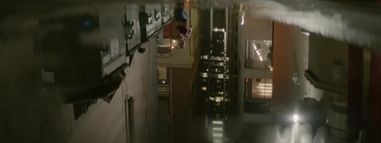 A woman jogs by a puddle in the street