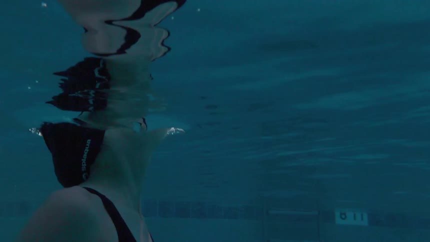 A swimmer crest the surface of the water