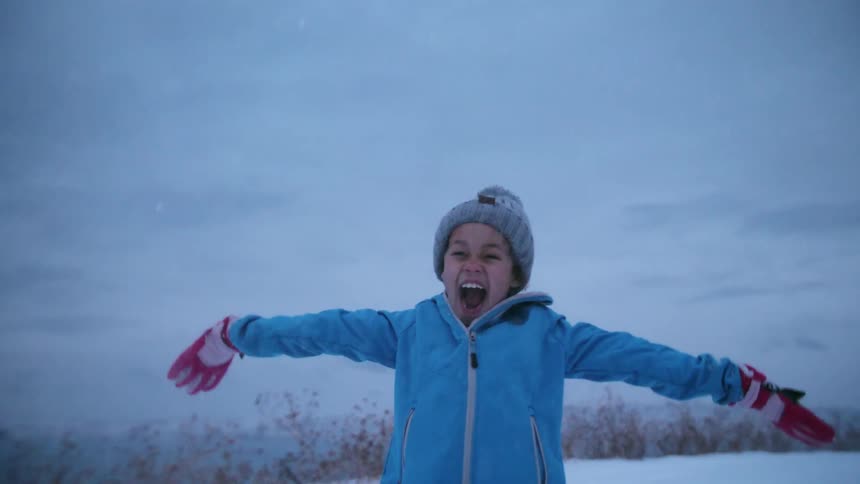 Child throws snow in the air