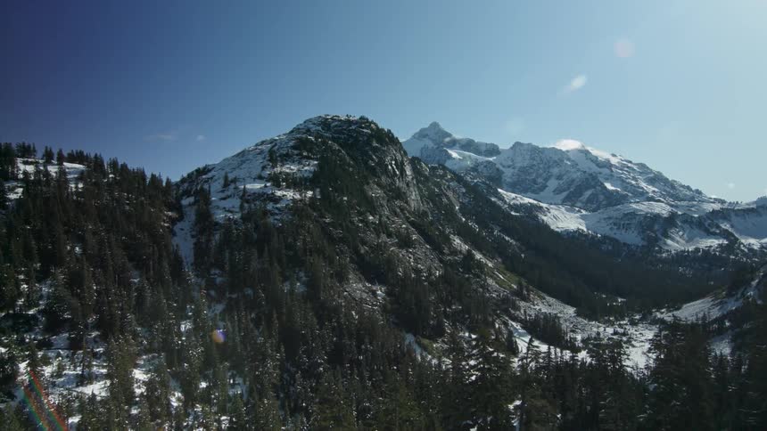 Sunlight is shining on a mountain valley on a winter day