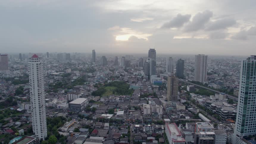 The city has many tall buildings on a cloudy day