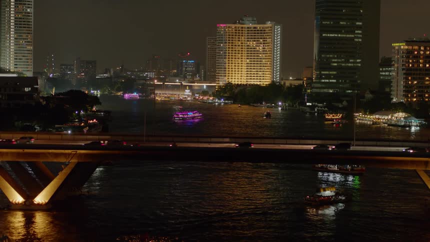 A train travels over a city bridge