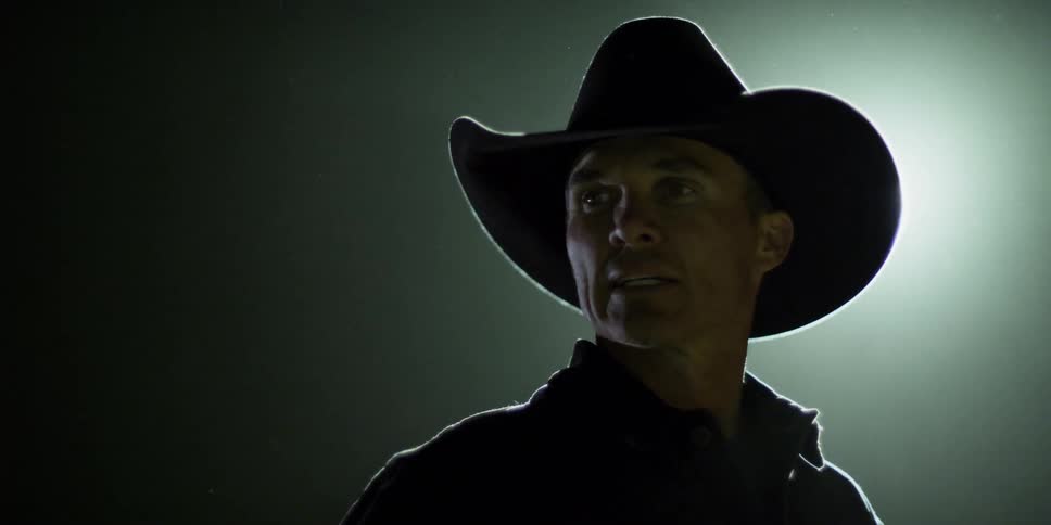 A man wearing a cowboy hat is speaking