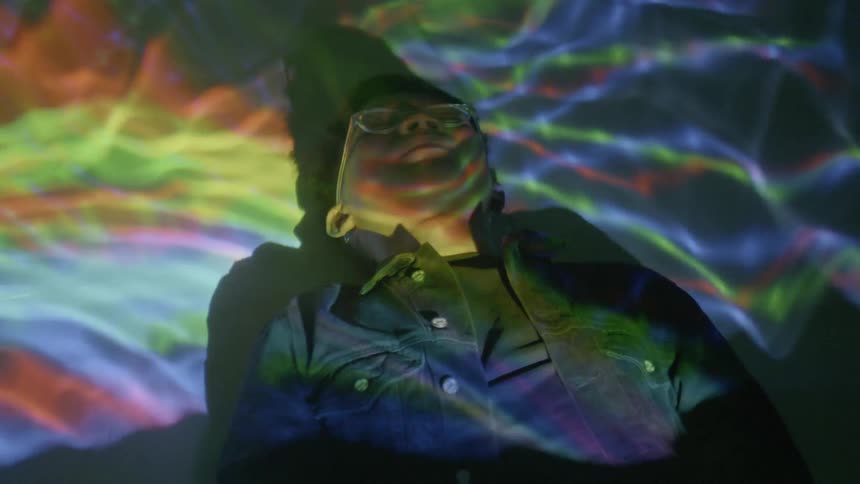 A young boy lays underwater